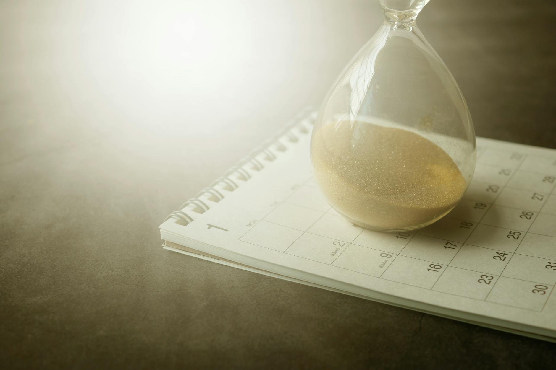 Hourglass on calendar representing immigration waiting period